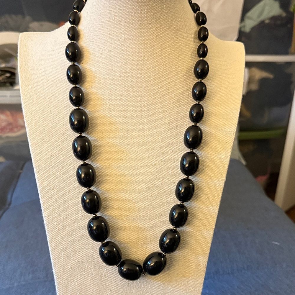 Vintage Monet Signed Black Graduated Bead Necklace with Gold Tone Spacers.